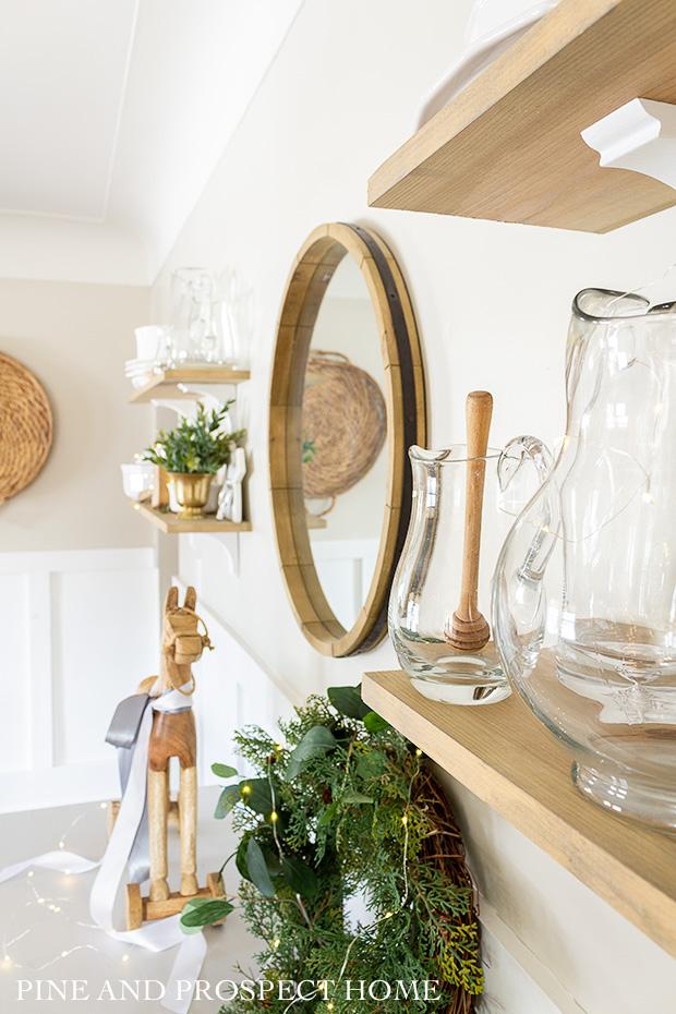 Open shelving decorated for Christmas with silver and gold
