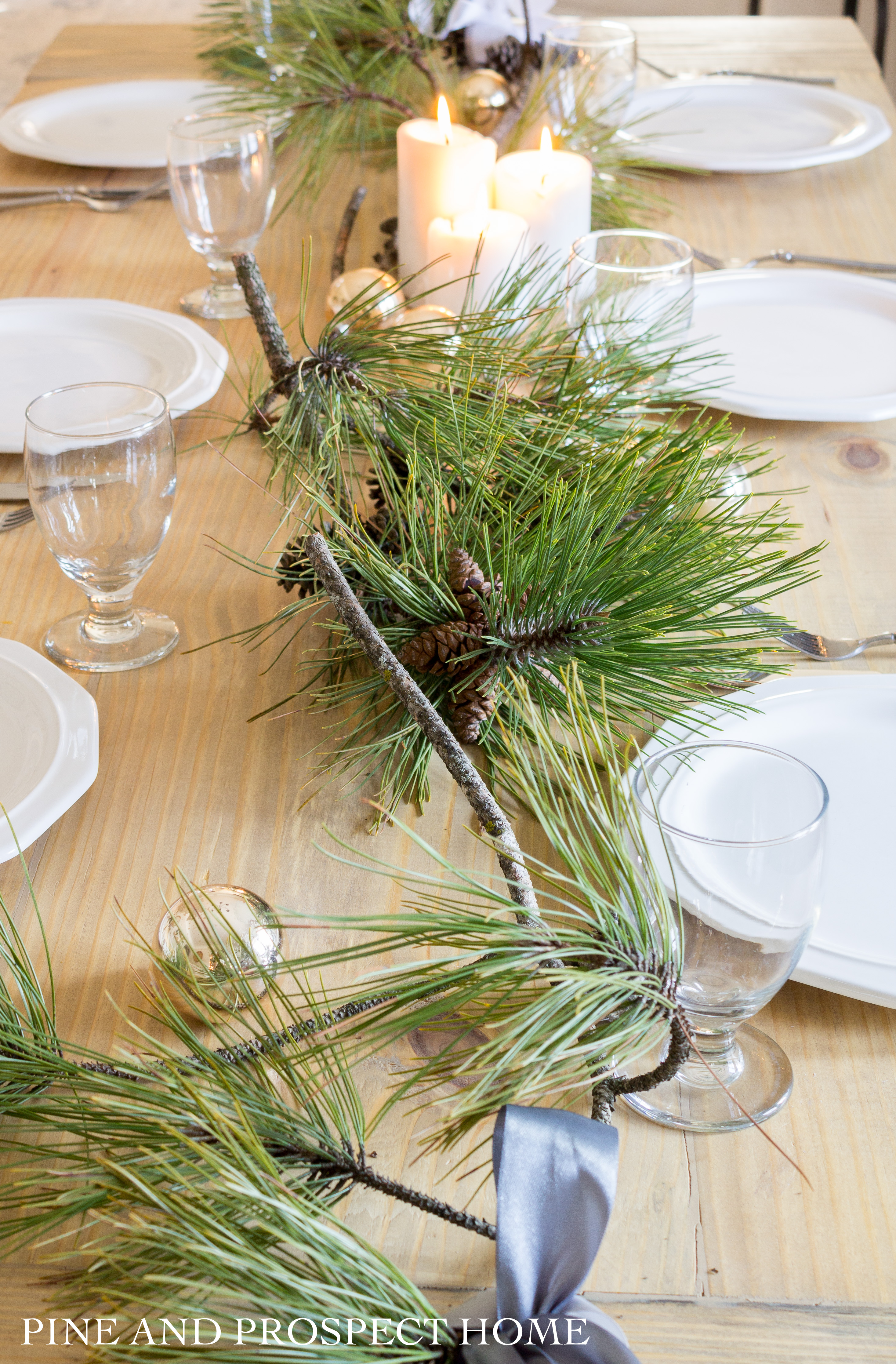 Fresh pine branches and ribbon is really all you need for an elegant Christmas table!
