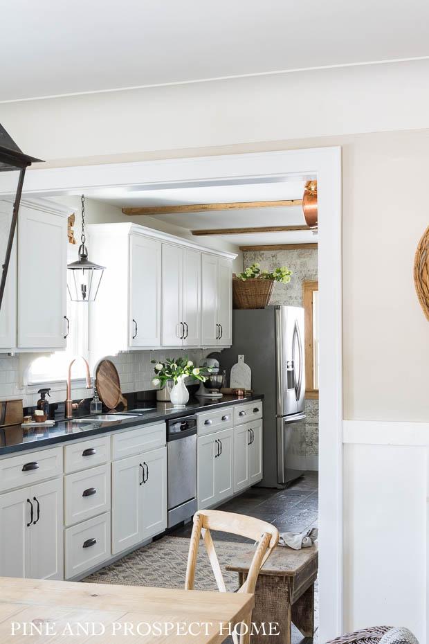 Our white cottage kitchen now has a cased opening that feels more authentic to the home.