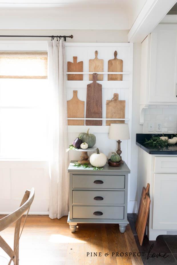 A fall vignette below our cutting board display