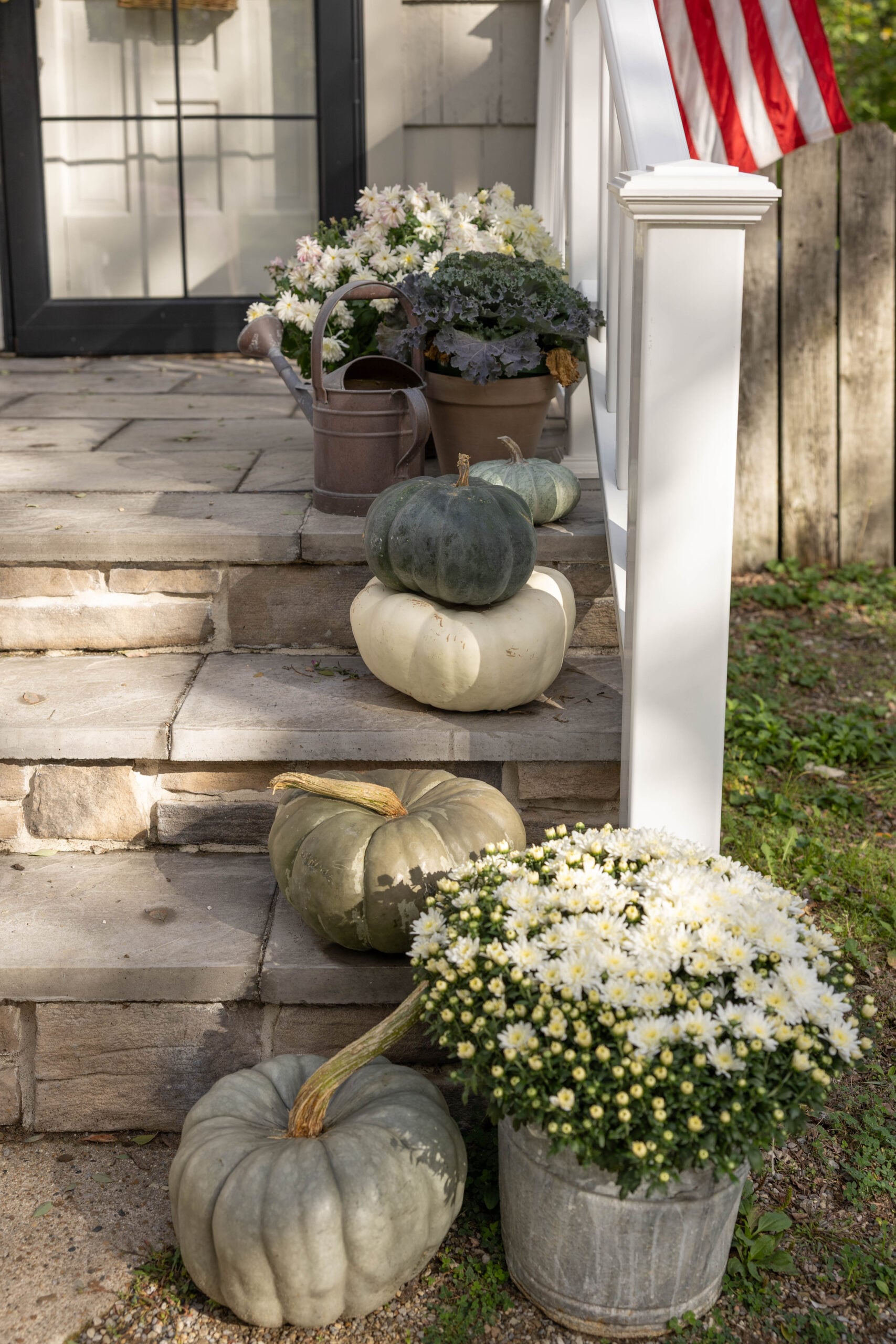 Fall porch decor using pumpkins and mums